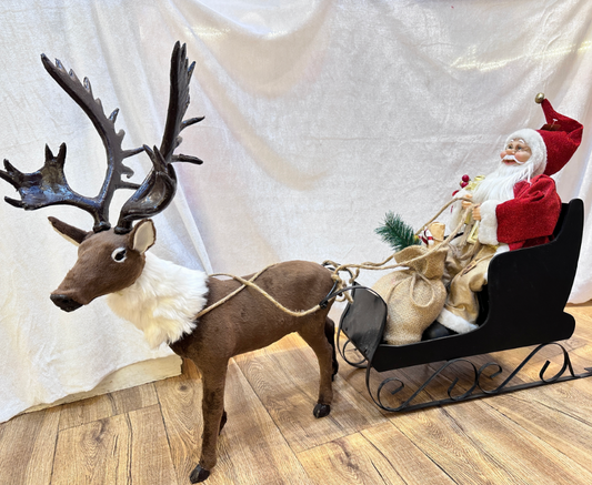 EXCLUSIVE SANTA ON A SLEDGE WITH A RAIN DEAR